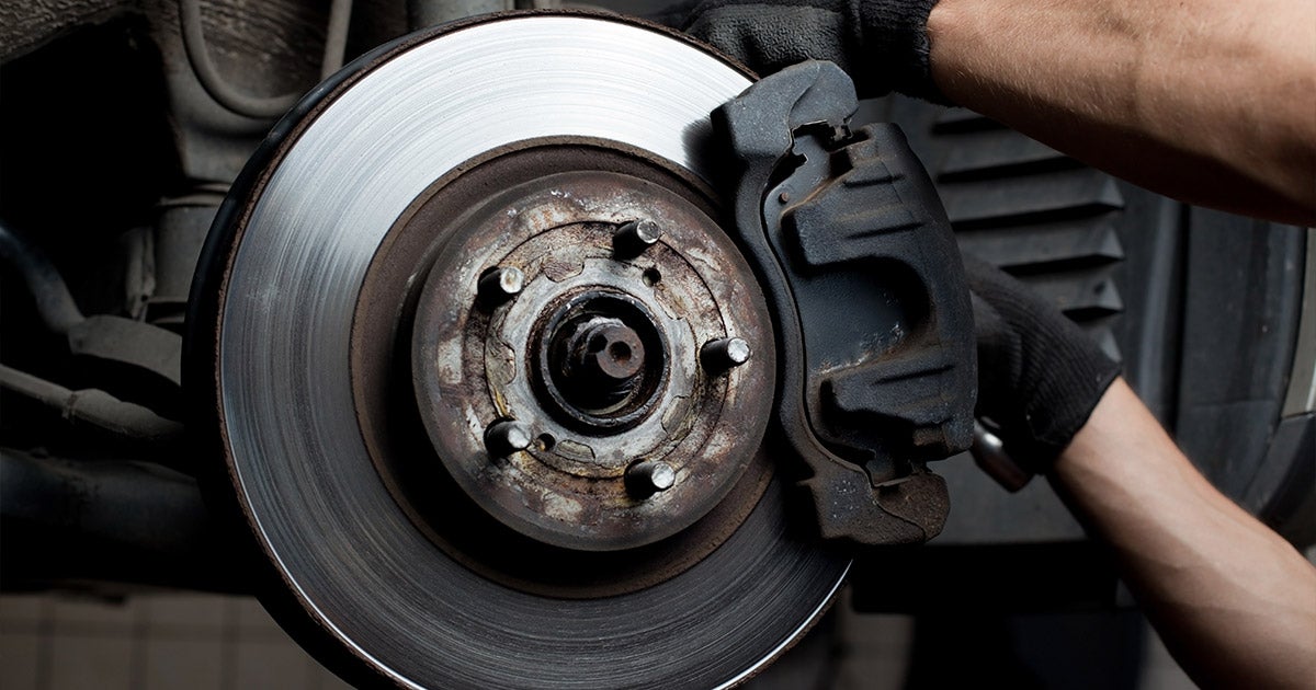 Close-up of car brake disc and caliper, automotive repair and maintenance service detail