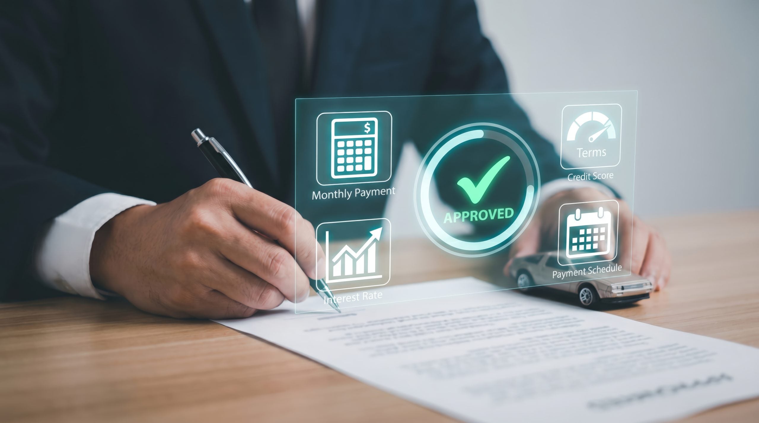 Auto Loan Approval and Car Finance Concept: Person Signing Contract with Holographic Monthly Payment, Interest Rate, and Credit Score Data Interface
