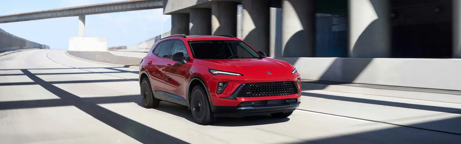 A 2026 red Buick Envision vehicle sitting in the sunshine