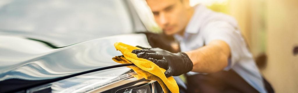 Mark Porter GMC professional technician carefully detailing and polishing a vehicle at our body shop in Pomeroy, OH