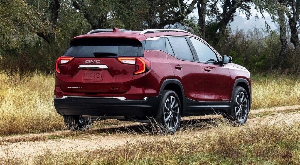 A red 2022 GMC Terrain SLE is shown on a path after a GM lease turn in.