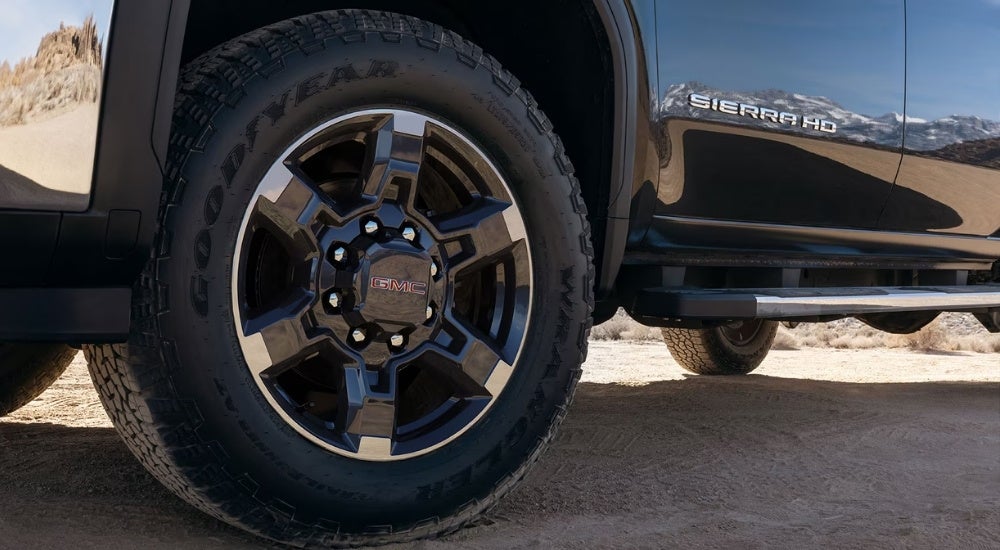 Front driver side wheel on a black 2026 GMC Sierra 2500 HD