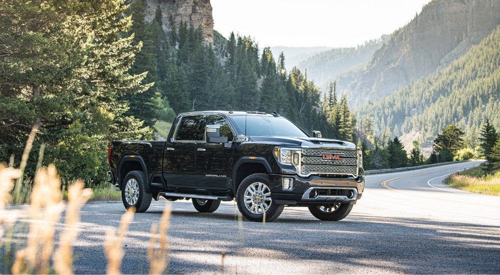 Black 2020 GMC Sierra 2500 HD Denali parked near a winding road