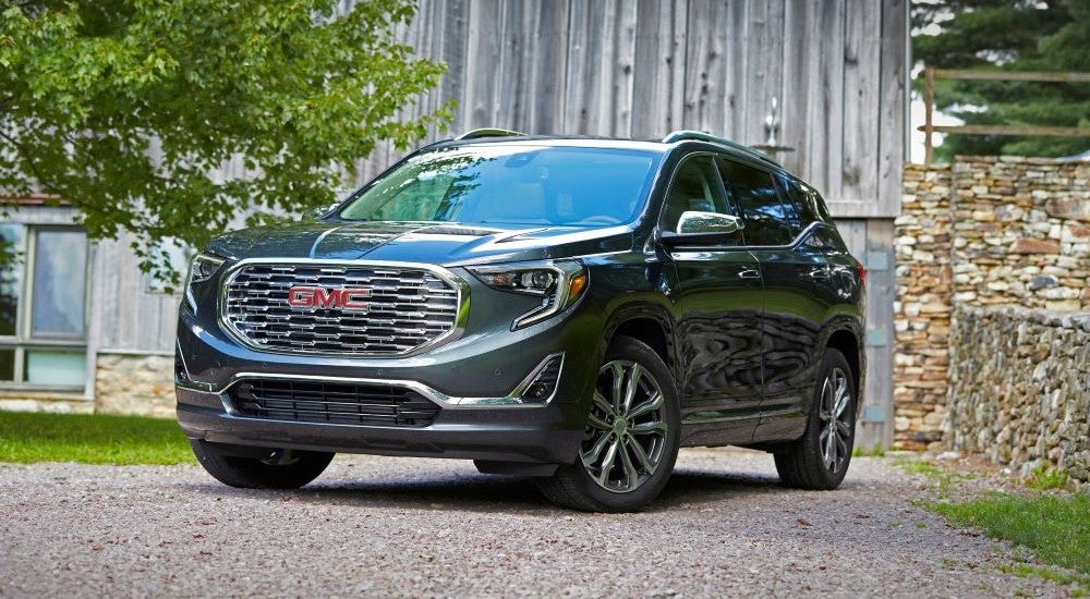 Grey 2020 GMC Terrain Denali parked in front of a barn