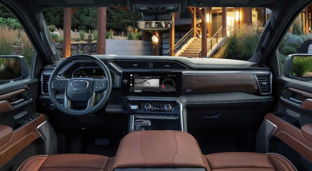 The black and brown interior is shown in a 2023 GMC Sierra 1500 Denali Ultimate for sale.