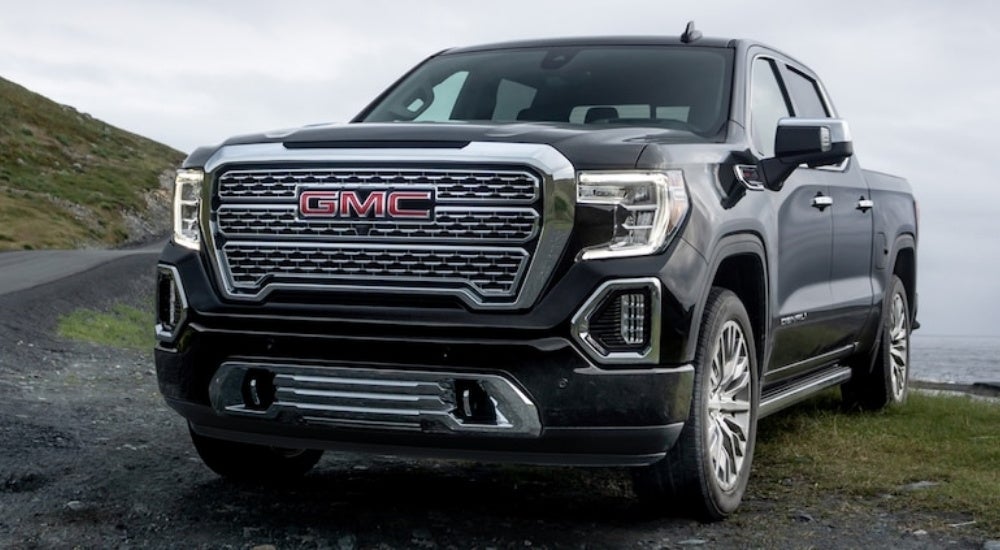 Black 2019 GMC Sierra 1500 Denali parked near a lake