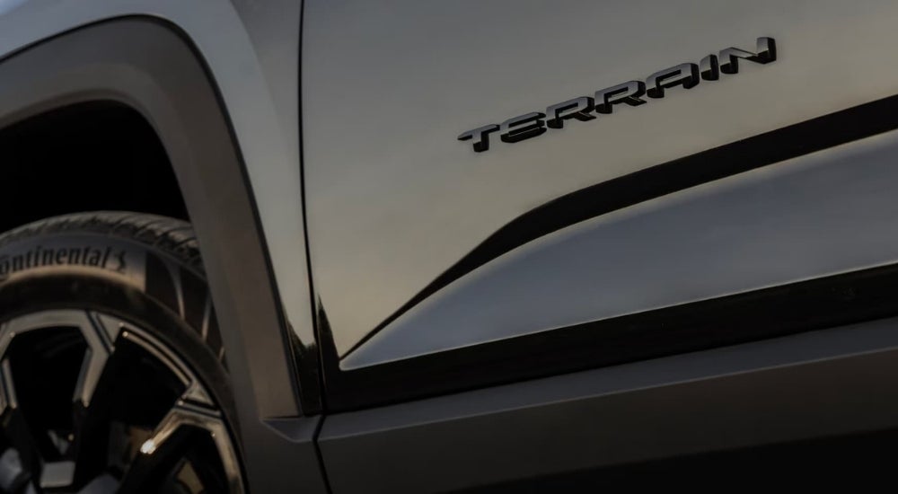 A close-up of the wheel of a black 2025 GMC Terrain.