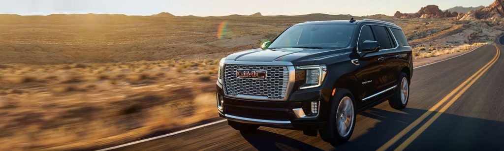 Black 2026 GMC SUV on desert road trip