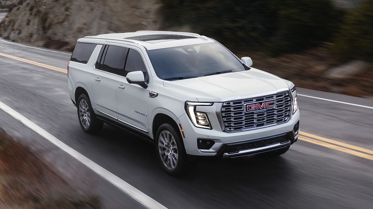 2026 GMC Yukon Denali cruising on a mountain road, demonstrating available adaptive suspension technology