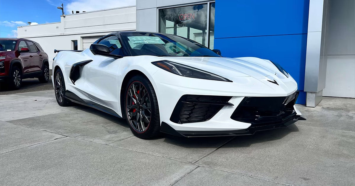White 2023 Corvette C8 Stingray sports car at Beck Motors Sunnyside, sleek mid-engine design with black accents
