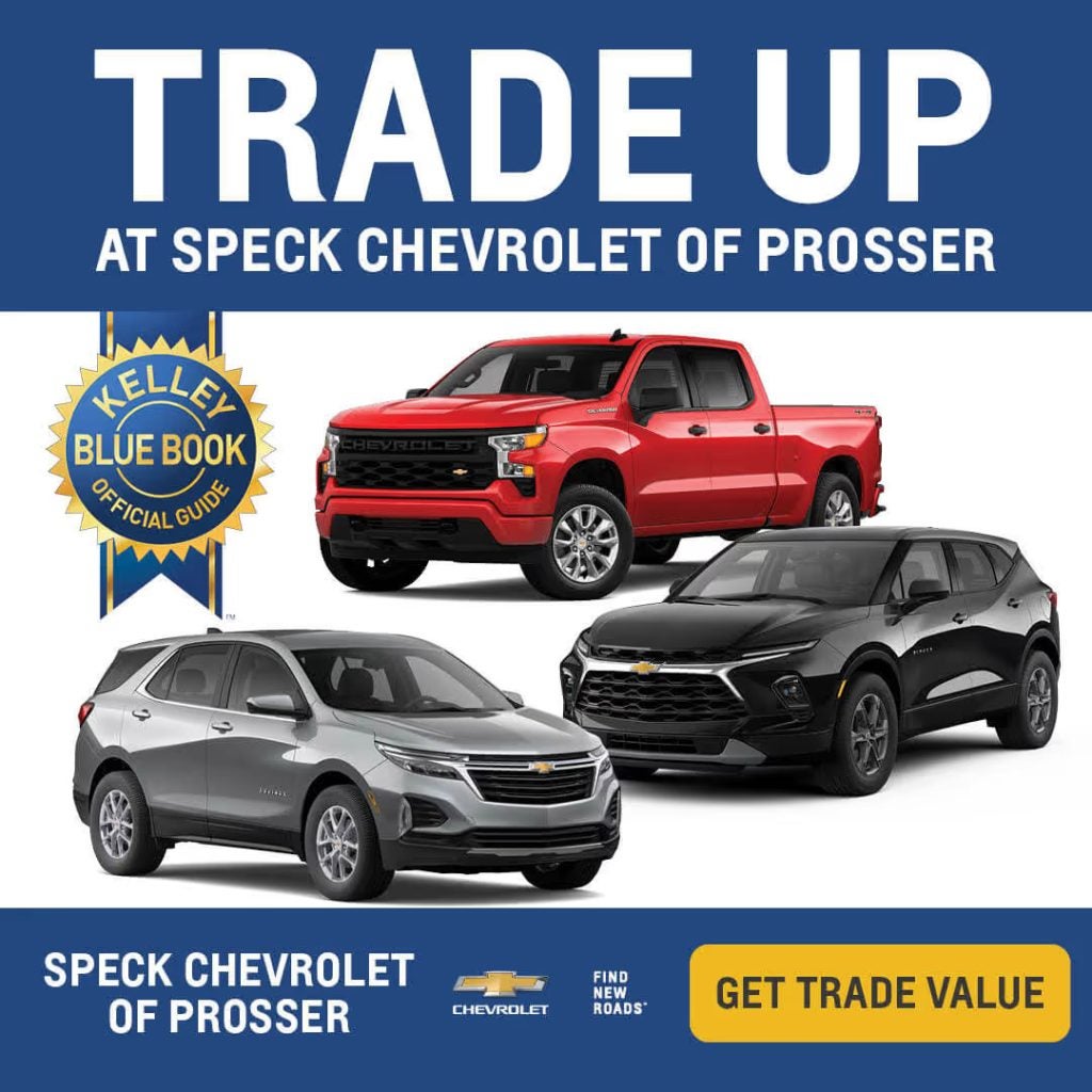 Red Chevrolet Silverado pickup truck, black Blazer SUV, and silver Equinox crossover at Speck Chevrolet of Prosser