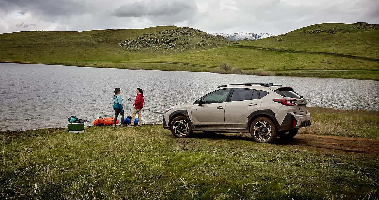 A 2026 Subaru Crosstrek Hybrid parked by a lake