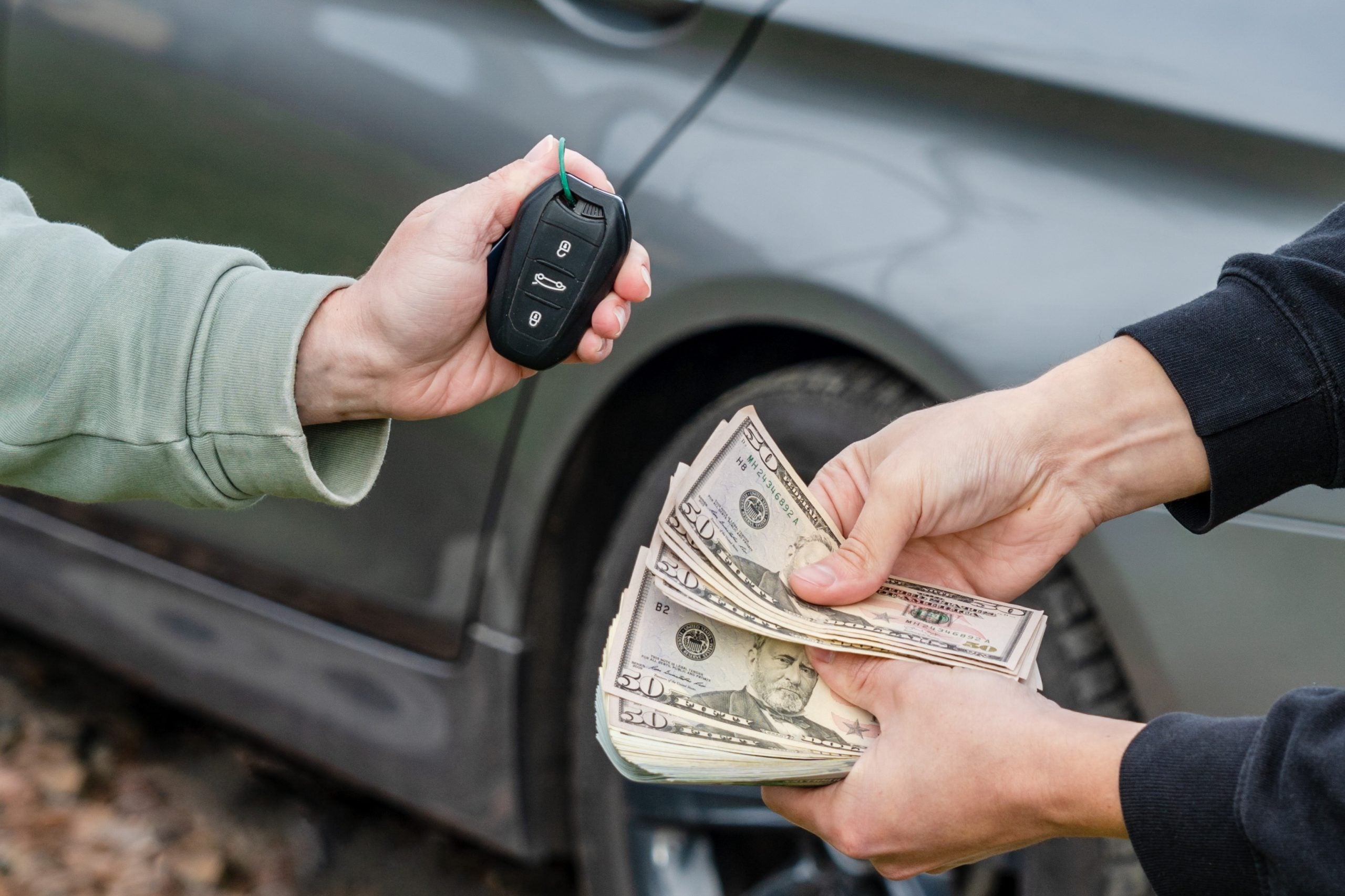 Person presenting cash in exchange for car keys