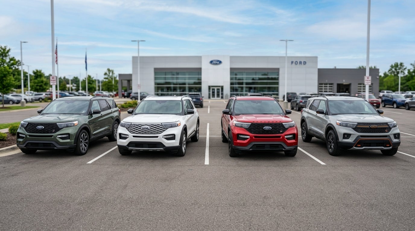 Four different colored Ford Explorer SUVs parked in a row outside a Ford dealership. (Representative image for illustration purposes only. Actual vehicle may vary based on trim and configuration.)