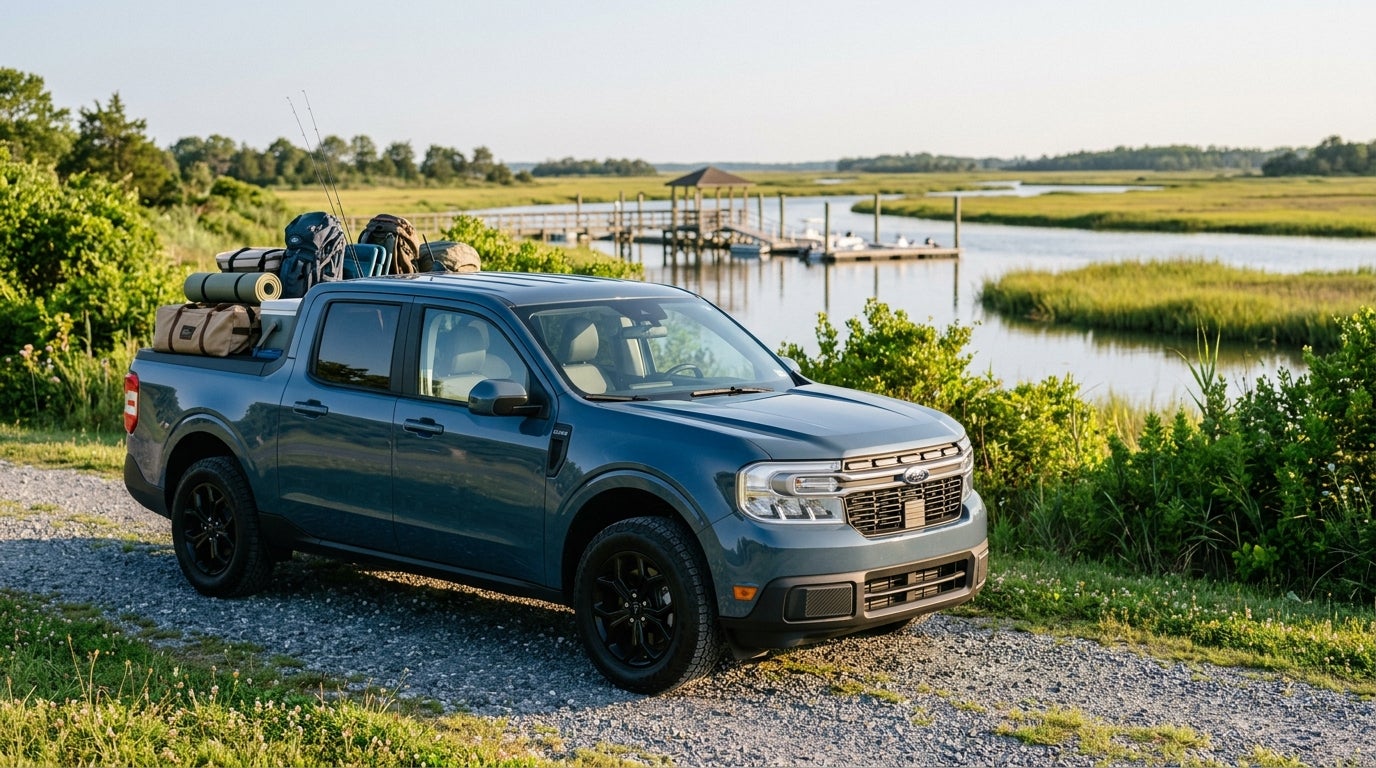 Blue Ford Maverick pickup truck packed with outdoor camping and fishing gear parked along a scenic river. (Representative image for illustration purposes only. Actual vehicle may vary based on trim and configuration.)