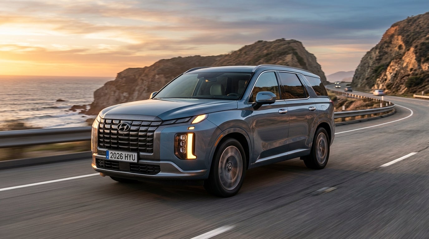 A light blue Hyundai SUV drives along a scenic coastal highway with cliffs and ocean views during sunset. (Representative image for illustration purposes only. Actual vehicle may vary based on trim and configuration.)