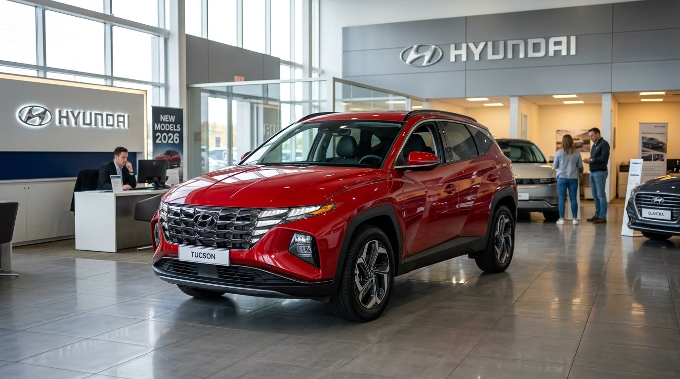 Red Hyundai Tucson SUV on display inside a modern car dealership showroom with polished tile floors. (Representative image for illustration purposes only. Actual vehicle may vary based on trim and configuration.)