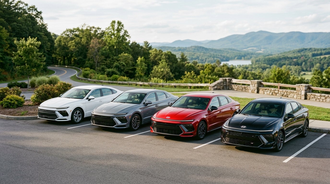 Four Hyundai Sonata sedans in white, grey, red, and black parked at a scenic overlook with mountain views. (Representative image for illustration purposes only. Actual vehicle may vary based on trim and configuration.)
