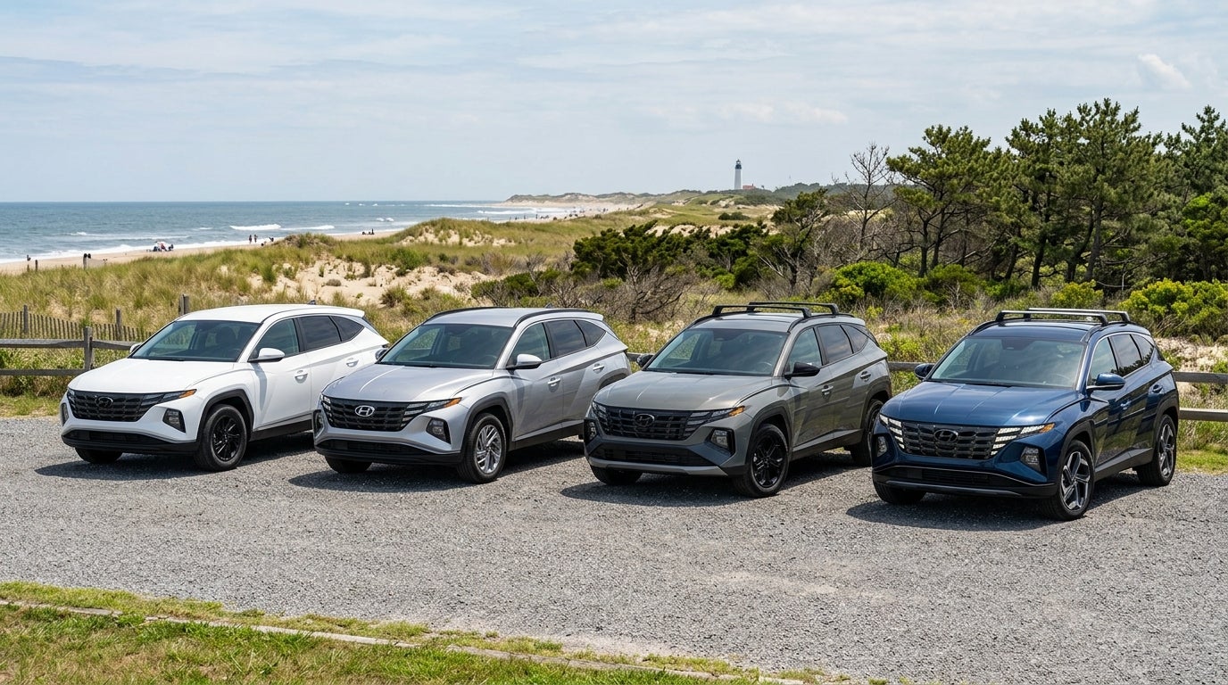 Four Hyundai Tucson SUVs parked side-by-side on a gravel lot near a coastal dune landscape with a distant lighthouse. (Representative image for illustration purposes only. Actual vehicle may vary based on trim and configuration.)