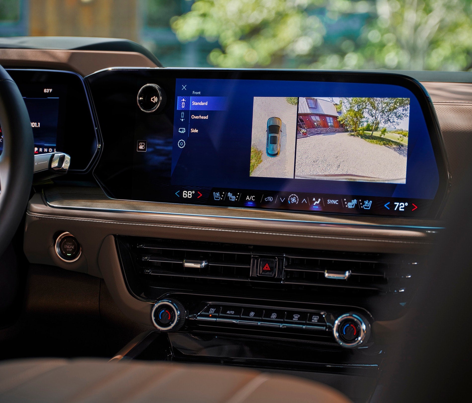 Car dashboard touchscreen showing backup camera view.
