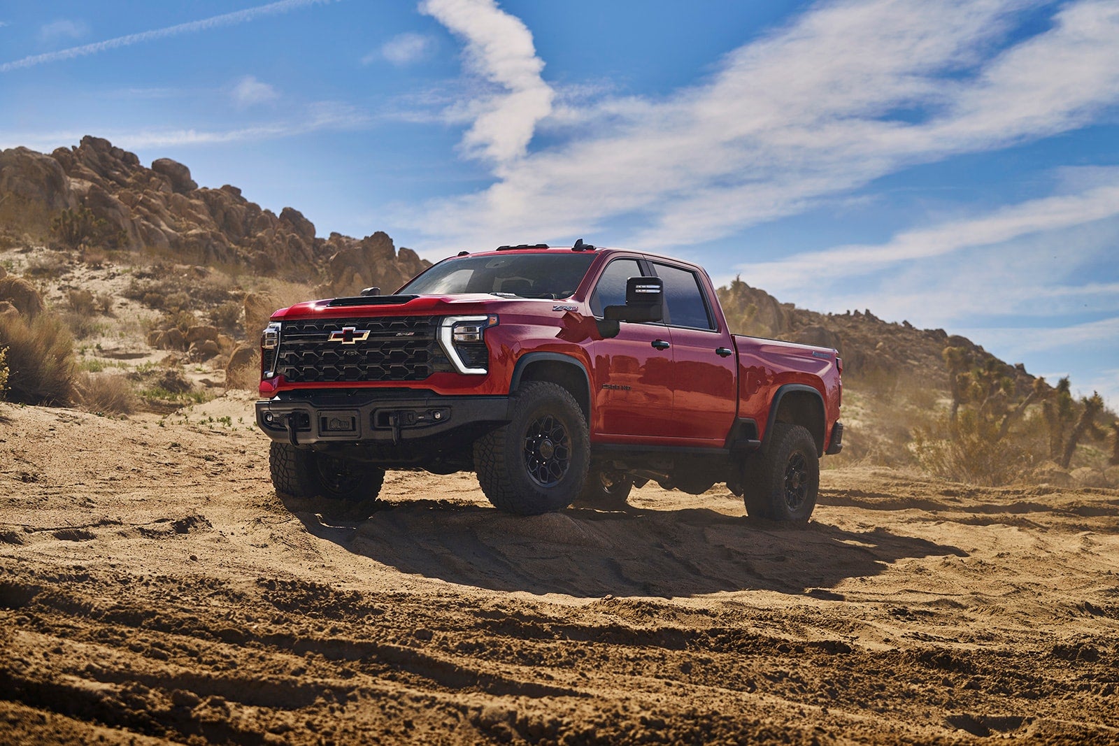 Chevrolet Silverado HD ZR2 in the desert under a blue sky.