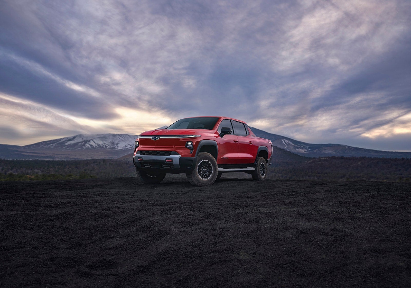 Front view of Silverado EV at mountain dusk.