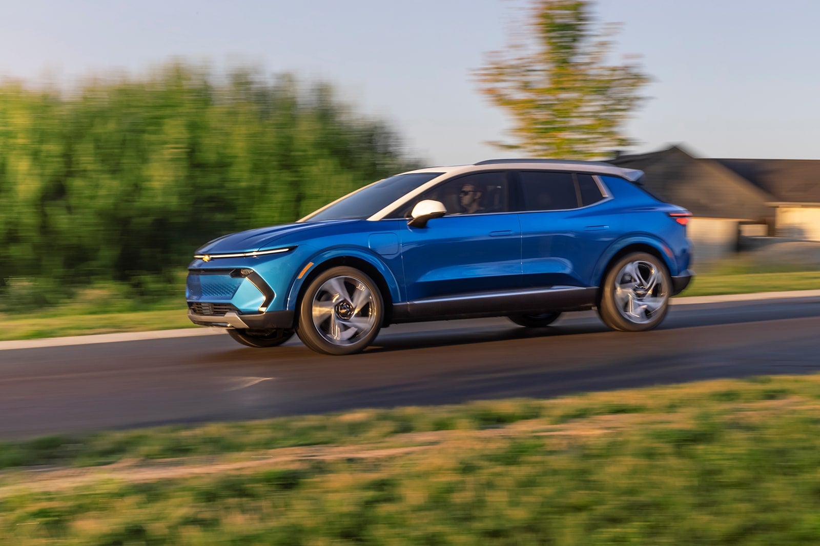 Chevy Equinox EV driving on road.