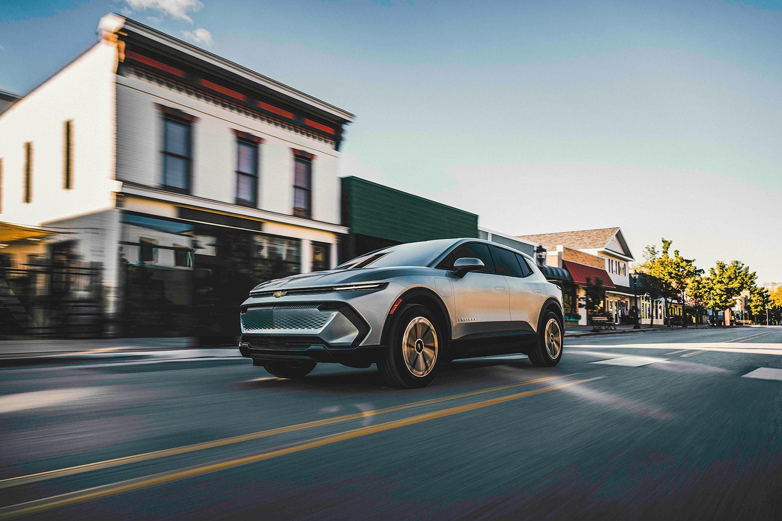 Chevy Equinox EV parked on the street in front of a building.


