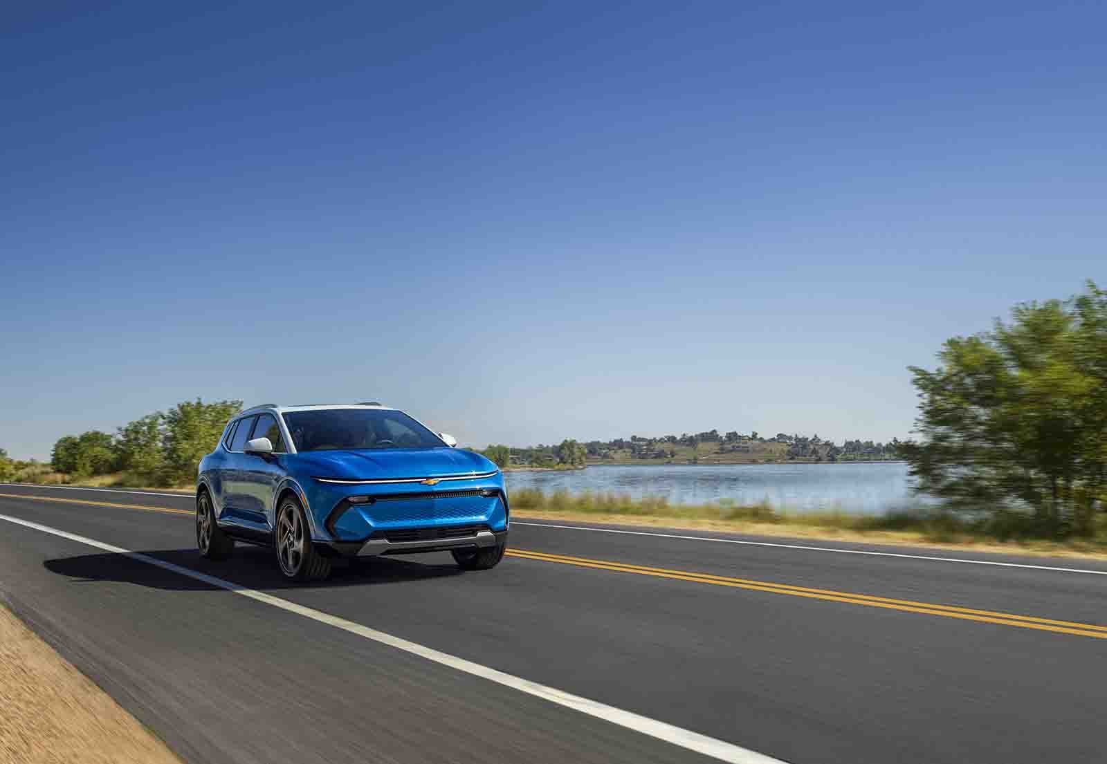 Chevy Equinox EV driving on road.