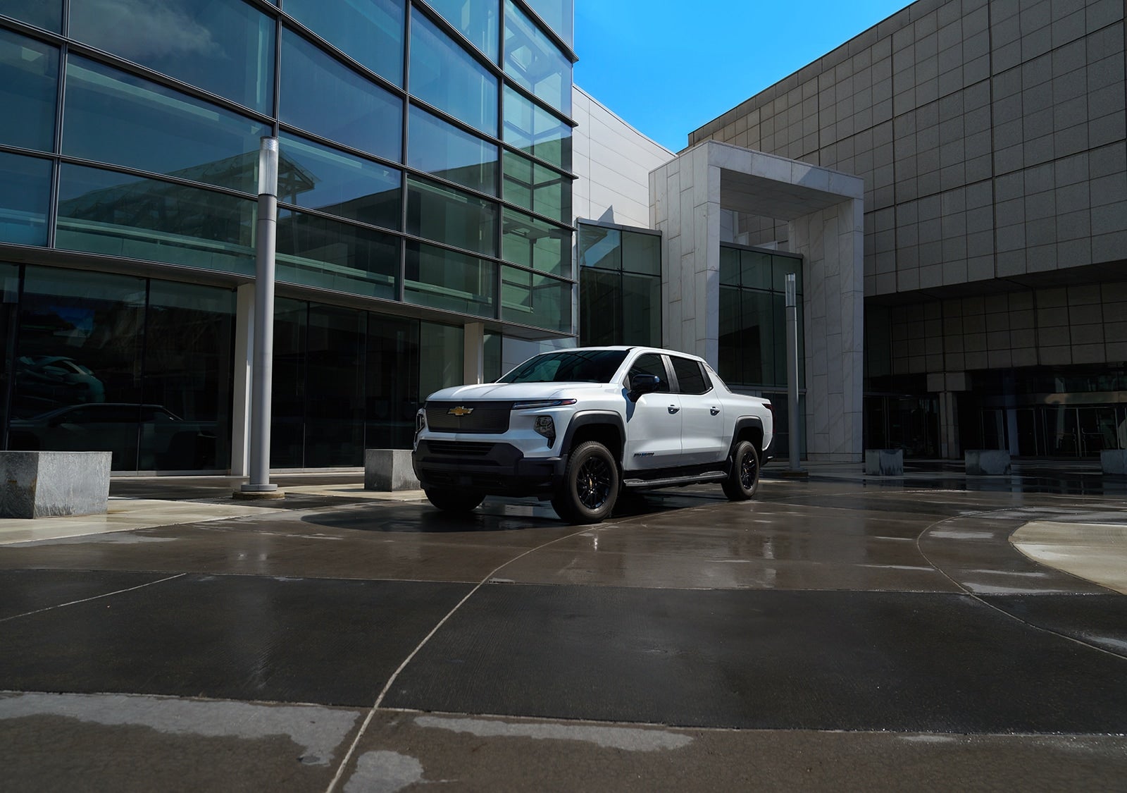 Chevrolet Silverado EV parked on wet pavement.