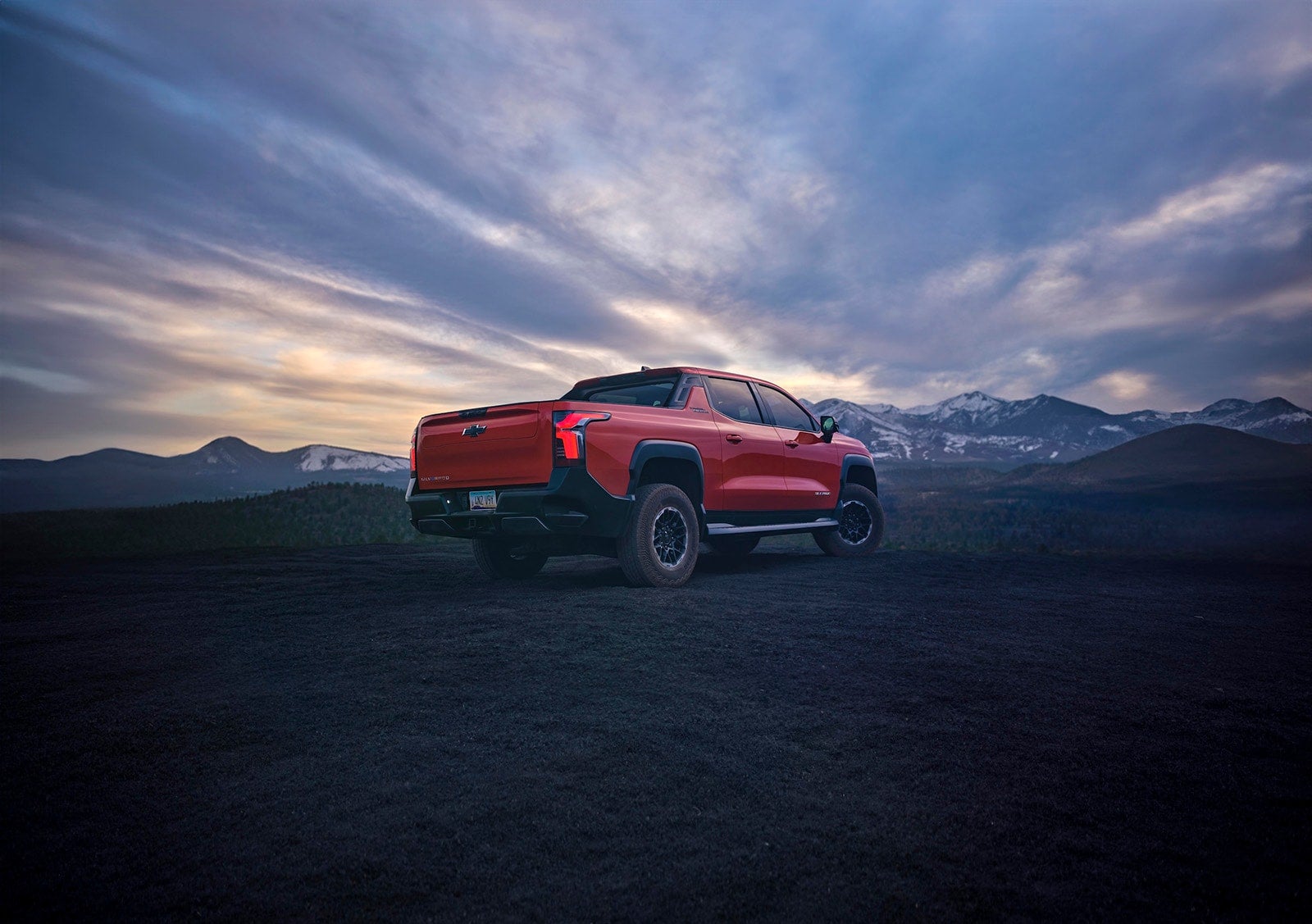 Back view of Silverado EV at mountain dusk.