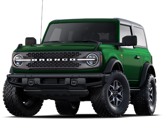 Green Ford Bronco 2-door SUV with off-road tires, rugged front grille, and aggressive stance on white background
