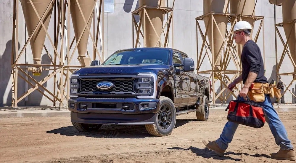 A black 2023 Ford F-250 is shown from the front at an angle after leaving a dealer that has a Ford F-250 for sale