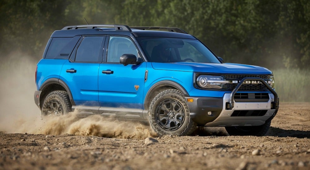 A blue 2025 Ford Bronco Sport Badlands Sasquatch off-roading through a sandy area