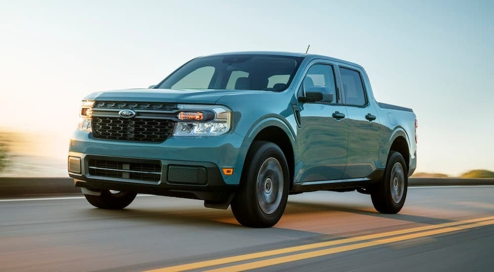 A blue 2024 Ford Maverick is shown from the front at an angle after leaving a dealer that has Ford trucks for sale near Red Hook
