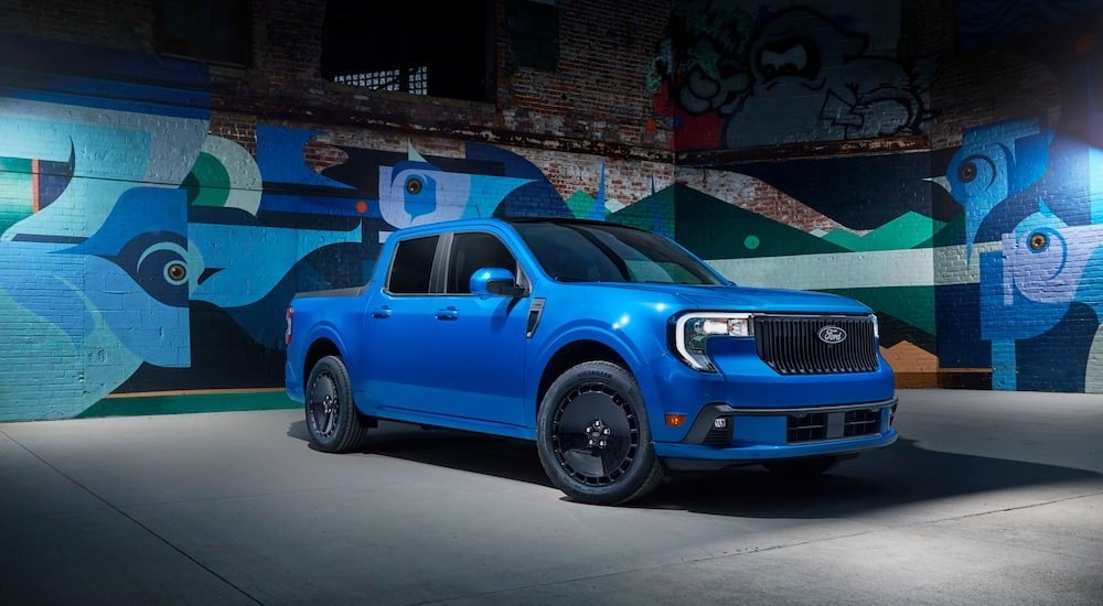 A blue 2025 Ford Maverick Lobo parked in a garage and angled right.
