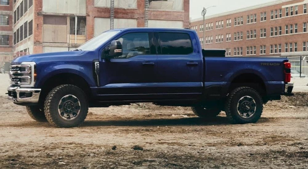 A blue 2026 Ford F-250 parked near buildings.