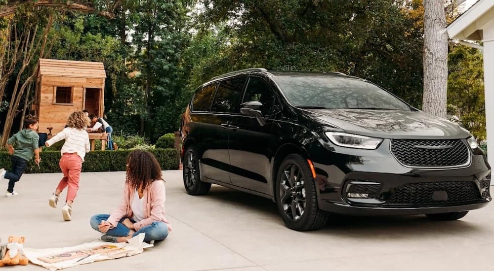 Black 2023 Chrysler Pacifica parked on a driveway.