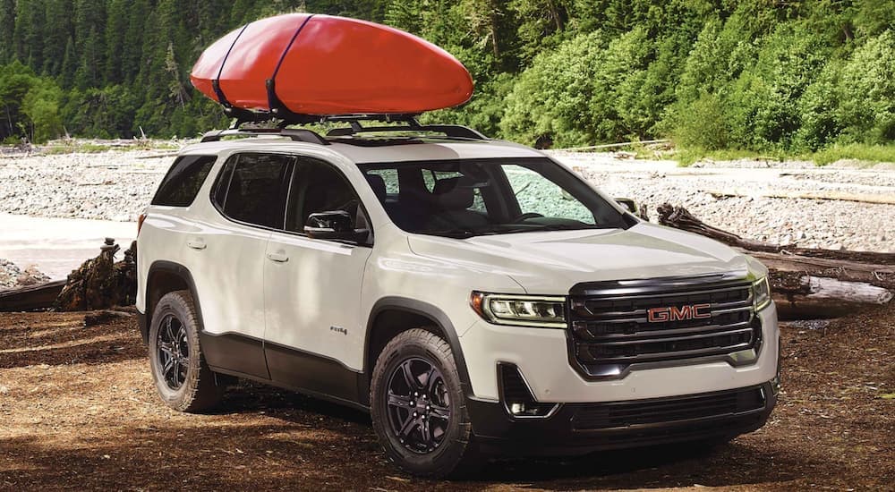 A white 2022 GMC Acadia parked off-road.