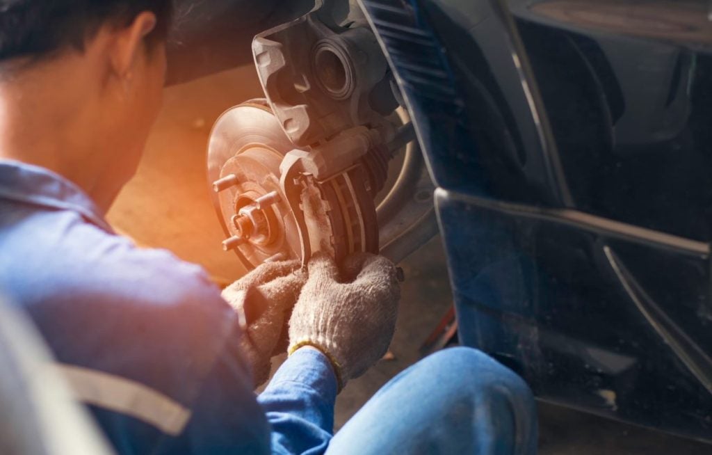 Close up shot of a technician changing brakes.
