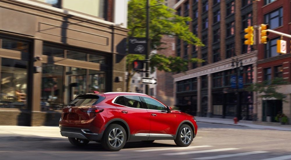 Red 2023 Buick Envision driving to a Buick dealer near Port Huron