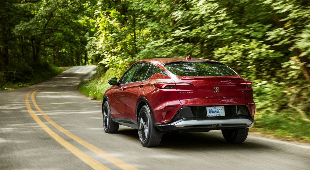 Red 2025 Buick Envista ST diving on a winding road