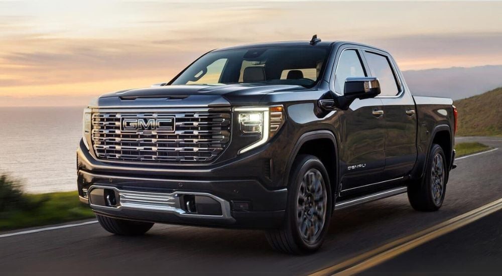 Black 2024 GMC Sierra 1500 driving to a GMC dealer