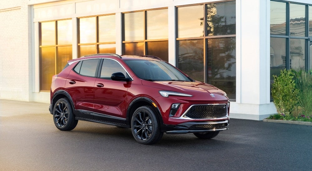 Red 2025 Buick Encore GX parked outside a building