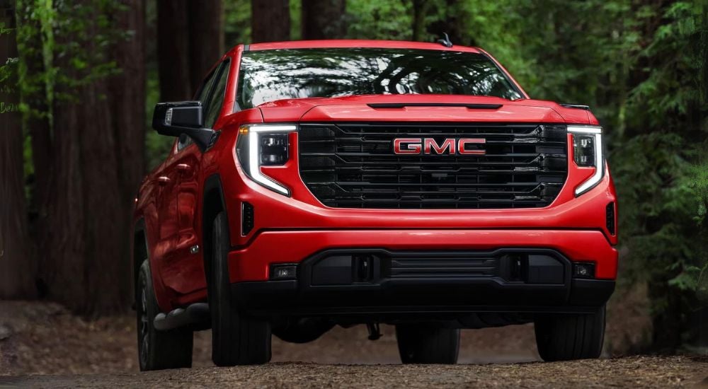 Red 2025 GMC Sierra 1500 Elevation driving off-road