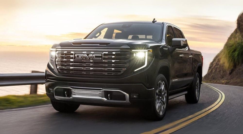 Black 2025 GMC Sierra 1500 rounding a corner