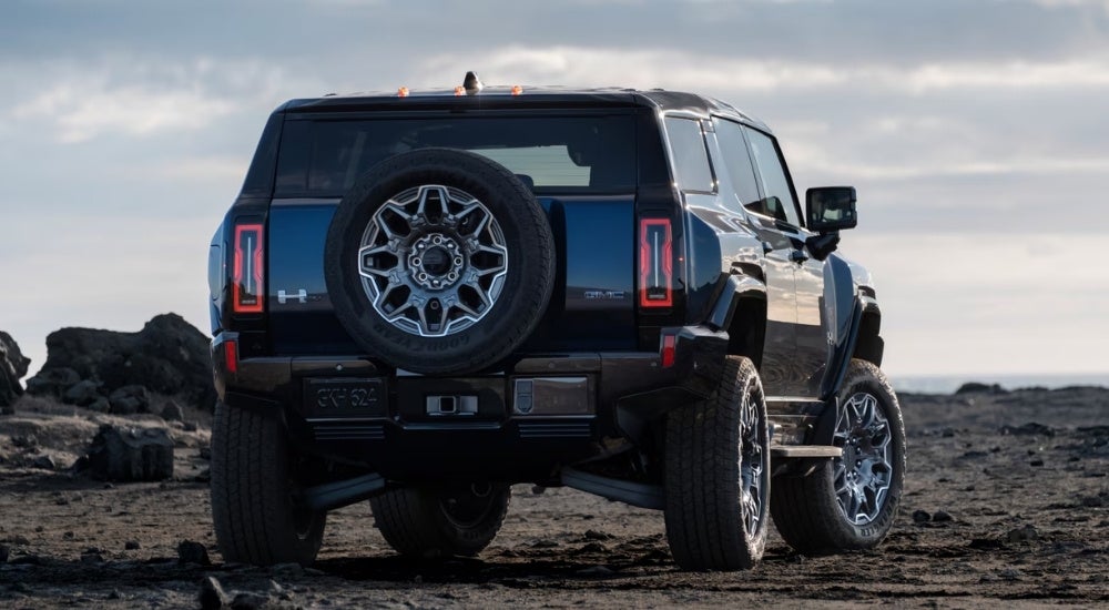 Black 2025 GMC Hummer EV SUV parked off-road