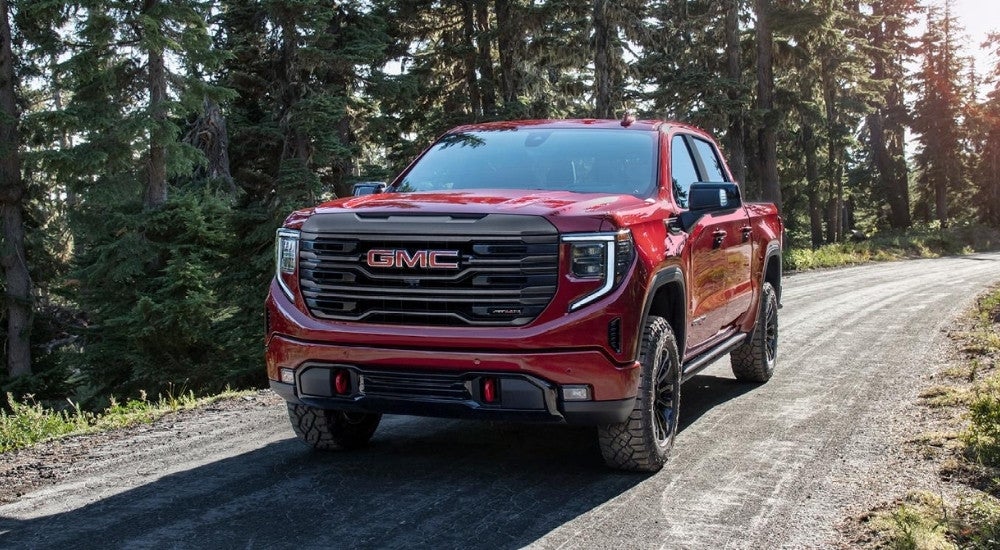 Red 2023 GMC Sierra 1500 AT4X driving off-road