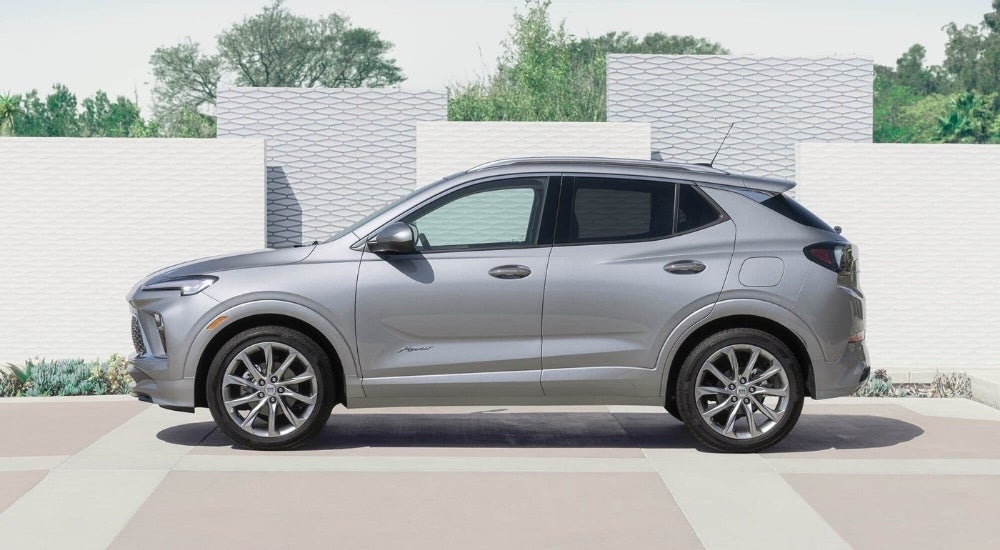 silver 2025 Buick Encore GX Avenir parked by a wall