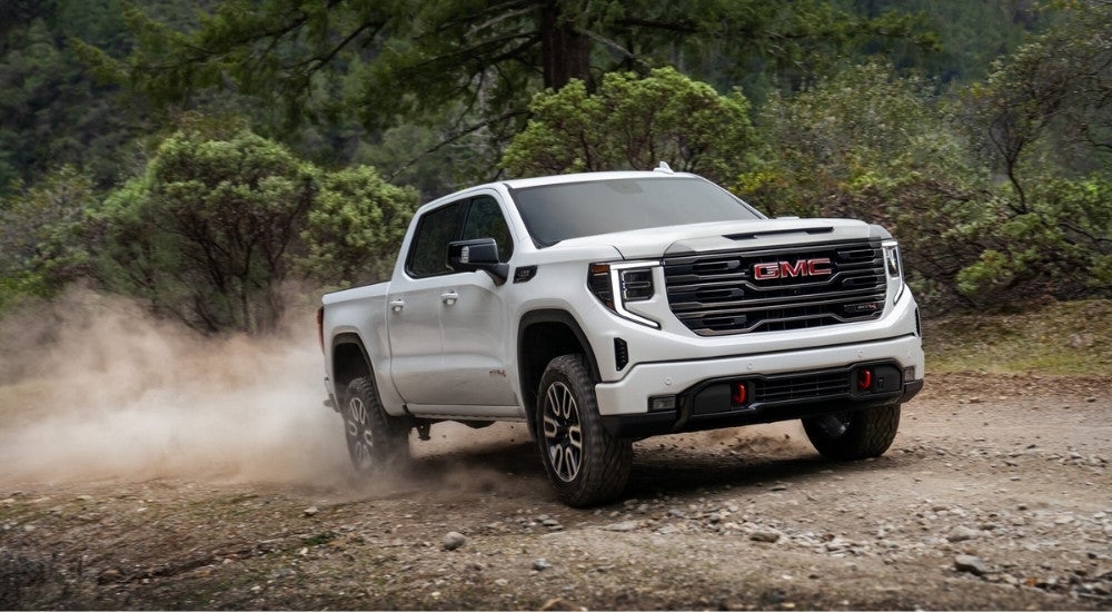 White 2023 GMC Sierra 1500 AT4 off-roading
